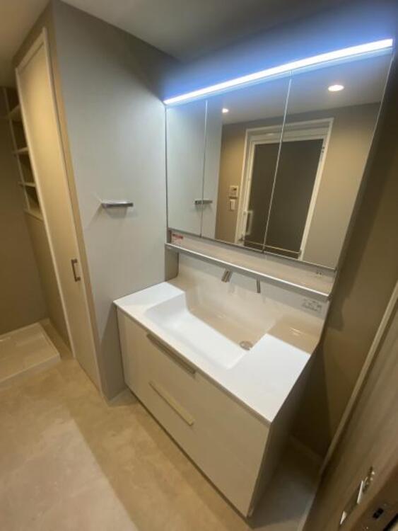 洗面 三面鏡の裏は機能的な収納を配置。コンセントも付いているため電動シェーバーや電動歯ブラシも収納できます。